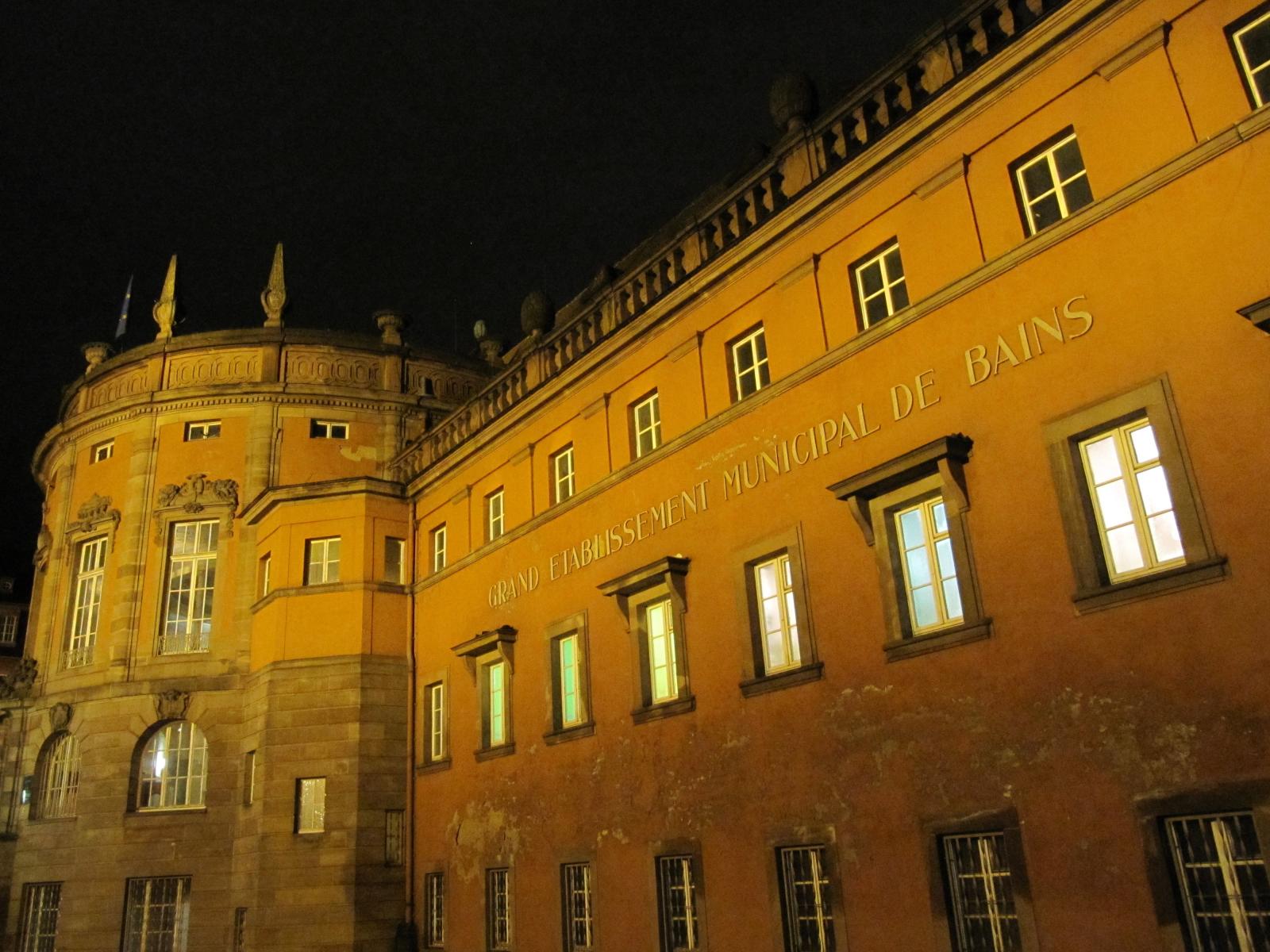 Fritz Beblos Bains Municipaux, beleuchtet bei Einbruch der Nacht